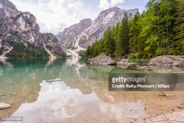 scenic view of lake and mountains against sky,prags,italy - pragser wildsee stock pictures, royalty-free photos & images