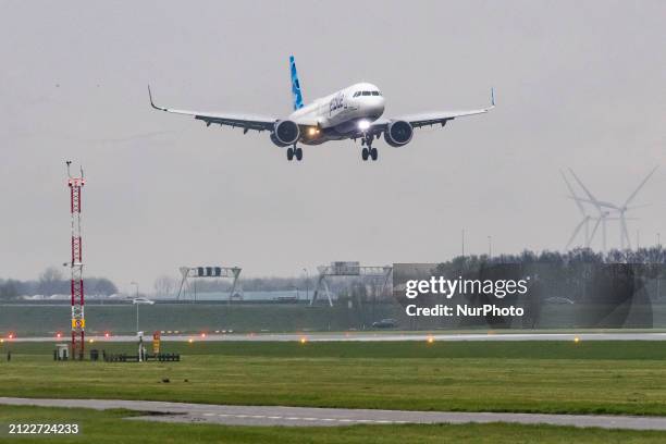 JetBlue Airbus A321neo aircraft flying, landing and taxiing at Polderbaan runway in Amsterdam Schiphol International Airport AMS EHAM in the...