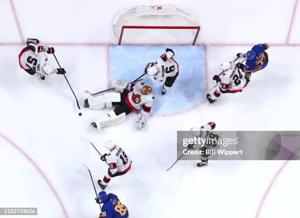 Joonas Korpisalo of the Ottawa Senators and teammates defend during an NHL game against the Buffalo Sabres on March 27, 2024 at KeyBank Center in...