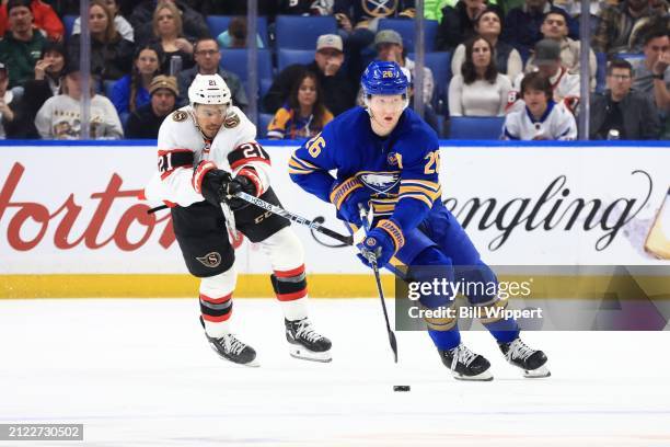 Rasmus Dahlin of the Buffalo Sabres skates against Mathieu Joseph of the Ottawa Senators during an NHL game on March 27, 2024 at KeyBank Center in...