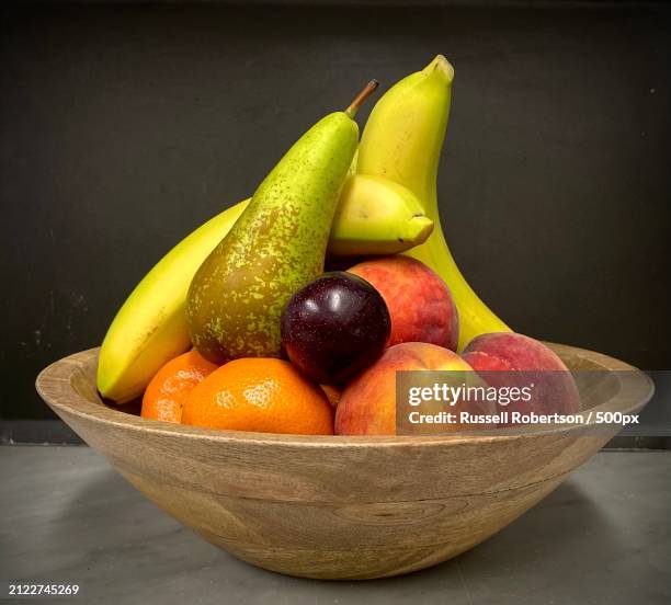 close-up of fruits in bowl on table,cupar,united kingdom,uk - fruit bowl stock pictures, royalty-free photos & images