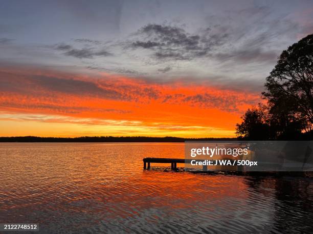 scenic view of lake against sky during sunset,new south wales,australia - australia jetty stock pictures, royalty-free photos & images