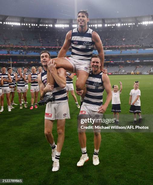 Tom Hawkins of the Cats is chaired from the field by Jeremy Cameron and Mitch Duncan with children Henry, Arabella and Primrose after his 350th match...