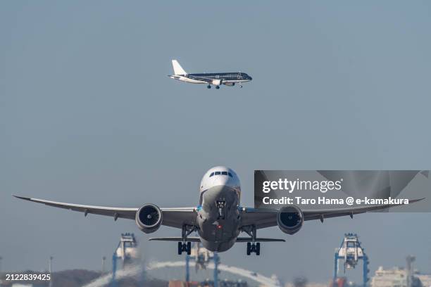 the airplanes flying over tokyo of japan - haneda stock pictures, royalty-free photos & images