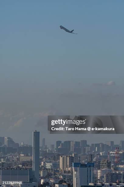 the airplane flying over kawasaki city of japan - haneda stock pictures, royalty-free photos & images