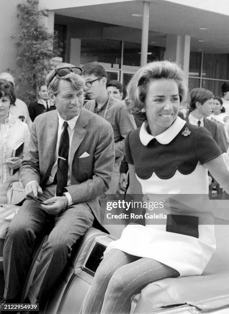 Married American couple politician and US Senator Robert F Kennedy and socialite Ethel Kennedy sit in a convertible as they take with supporters...
