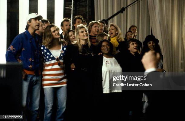 Part of a group of over 100 celebrities sing during a playback of their recorded song Voices That Care at Warner Brothers Studios in Burbank,...