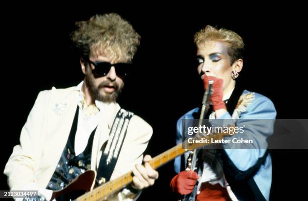 English musician Dave Stewart and Scottish singer-songwriter Annie Lennox, of the British pop duo The Eurythmics, perform on stage during a concert...