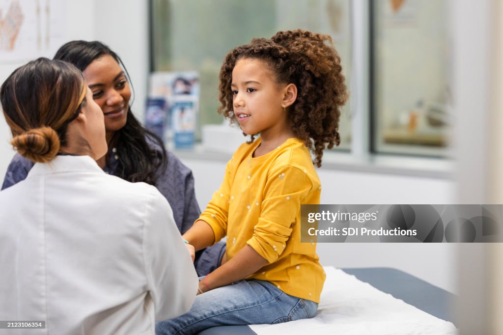 Young female patient talks to her doctor about her symptoms