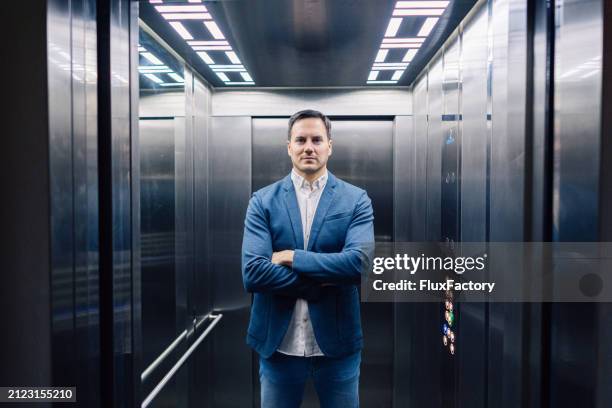 portrait of an young caucasian businessman in the elevator - hiss bildbanksfoton och bilder