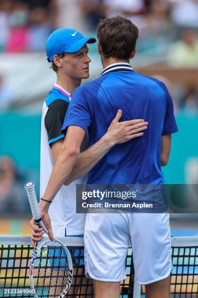 Jannik Sinner of Italy hits and Daniil Medvedev greet after the Men's semifinal on Day 14 of the Miami Open at Hard Rock Stadium on March 29, 2024 in...