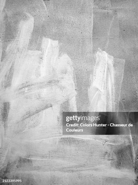 white paint on a textured and patinated cement wall in london, england, united kingdom.
sunlight. black and white. - layered stock pictures, royalty-free photos & images