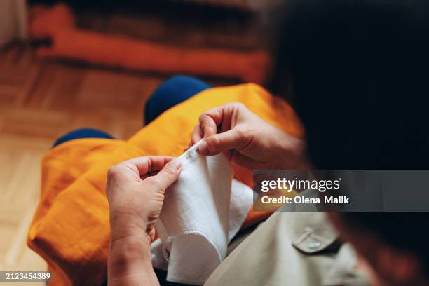 mature seamstress sewing, close-up of hands - thimble stock pictures, royalty-free photos & images