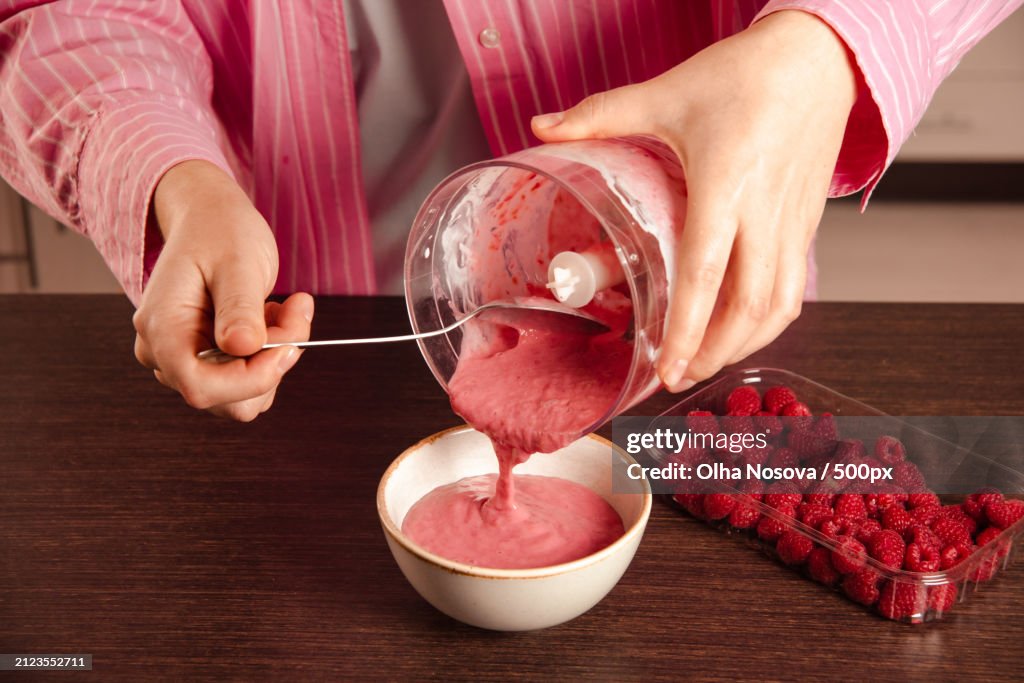 Midsection of woman preparing dessert on table