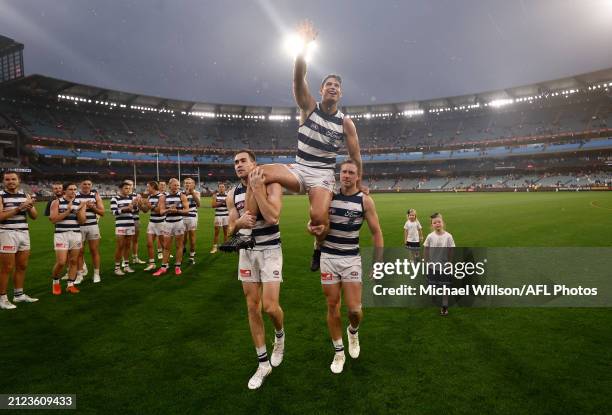 Tom Hawkins of the Cats is chaired from the field by Jeremy Cameron and Mitch Duncan with children Henry, Arabella and Primrose after his 350th match...