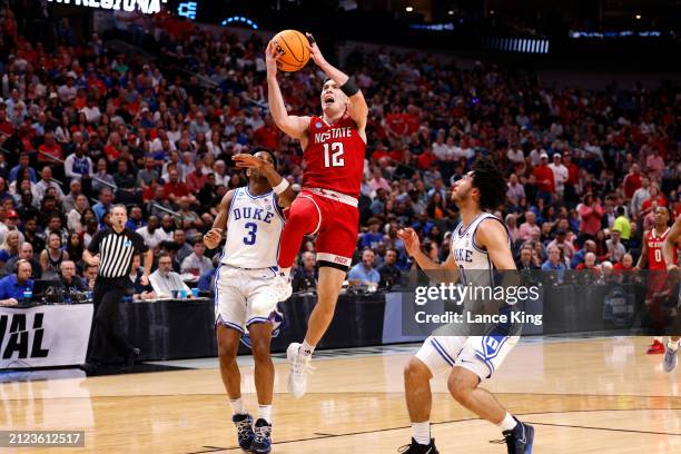 Michael O'Connell of the NC State Wolfpack goes to the basket against Jeremy Roach of the Duke Blue Devils during the first half in the Elite 8 round...