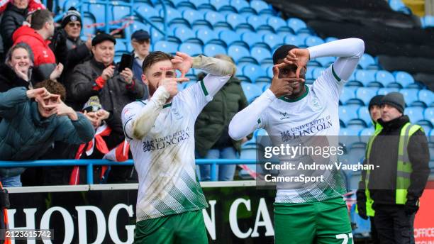 Lincoln City's Ted Bishop, left, celebrates scoring his side's third goal with team-mate TJ Eyoma during the Sky Bet League One match between...