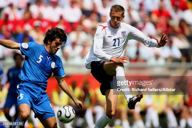 June 10: Peter Crouch of England and Julio Cesar Caceres of Paraguay challenge during the FIFA World Cup Finals 2006 Group B match between England...