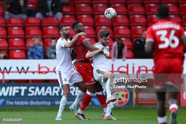 Jamille Matt of Walsall is in action between Curtis Tilt of Salford City and Luke Garbett of Salford City during the Sky Bet League 2 match at the...