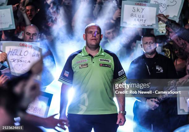 Michael van Gerwen walks on prior to his PDC 2024 Cazoo Masters Semi-Final match against Dimitri Van den Bergh at Marshall Arena on February 4, 2024...