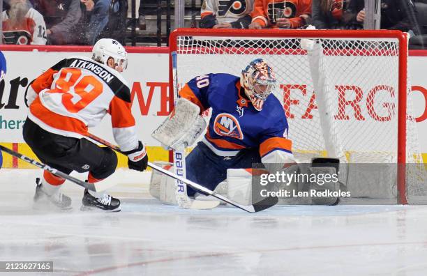Cam Atkinson of the Philadelphia Flyers attempts a scoring chance on goaltender Semyon Varlamov of the New York Islanders at the Wells Fargo Center...