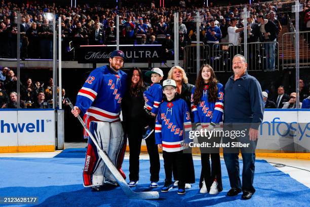 Jonathan Quick of the New York Rangers is joined by his family as he is honored prior to the game against the Pittsburgh Penguins after becoming the...