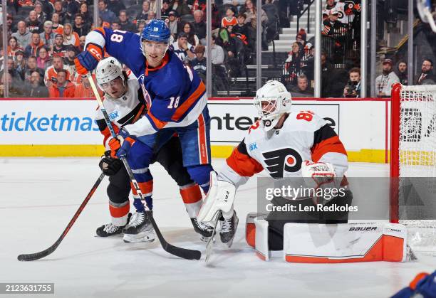 Goaltender Ivan Fedotov of the Philadelphia Flyers protects his net as Jamie Drysdale defends against Pierre Engvall of the New York Islanders at the...