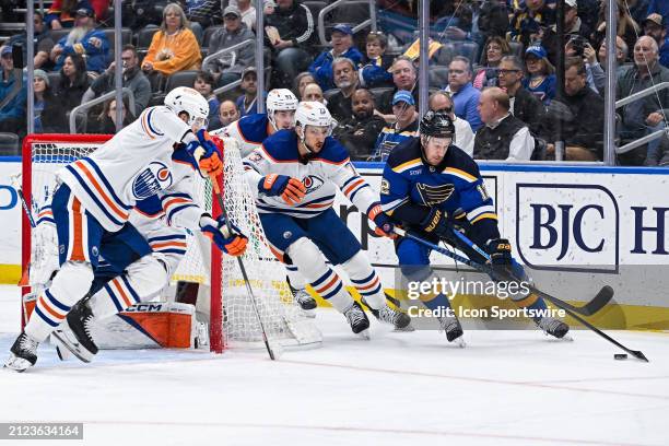 April 01: Edmonton Oilers defenseman Vincent Desharnais keeps St. Louis Blues right wing Kevin Hayes form circling around the front of the net during...