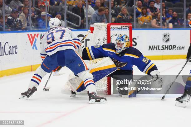 Jordan Binnington of the St. Louis Blues defends against Connor McDavid of the Edmonton Oilers during the second period at Enterprise Center on April...