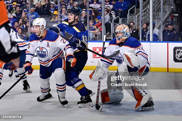 Darnell Nurse and Stuart Skinner of the Edmonton Oilers defend the net against Alexey Toropchenko of the St. Louis Blues on April 1, 2024 at the...