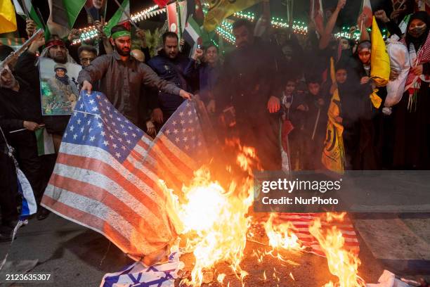 Iranian protesters are burning U.S. Flags during a protest gathering to condemn the Israeli airstrike against the Iranian consulate in Syria, at...