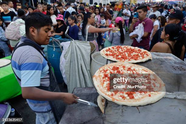 People are making pizzas outside the Temple of Santa Muerte in Tepito, Mexico City, where dozens of attendees are giving thanks for the favors...