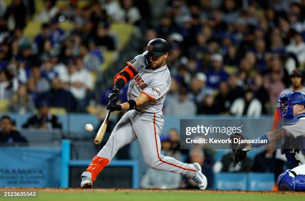 Michael Conforto of the San Francisco Giants hits a one run home run against relief pitcher Ryan Brasier of the Los Angeles Dodgers during the sixth...