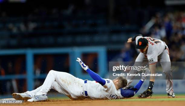 Freddie Freeman of the Los Angeles Dodgers slides in safely at second base as short stop Nick Ahmed of the San Francisco Giants misses the tag during...