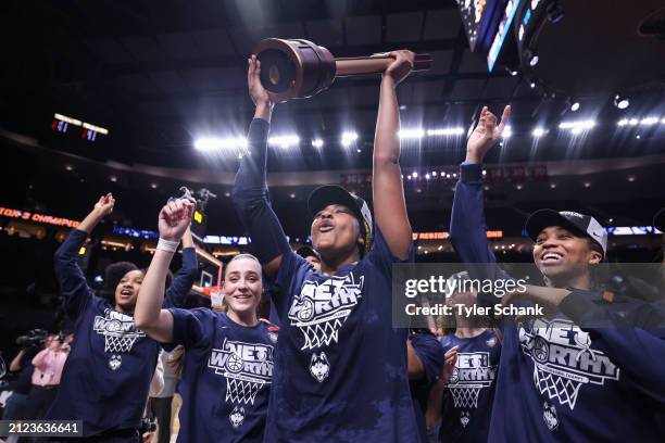 Aaliyah Edwards of the UConn Huskies hoists the trophy after defeating the USC Trojans during the Elite Eight round of the 2024 NCAA Women's...