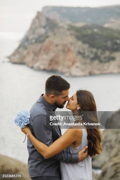 young couple in love embracing and having romantic date on seashore. - couples romance imagens e fotografias de stock