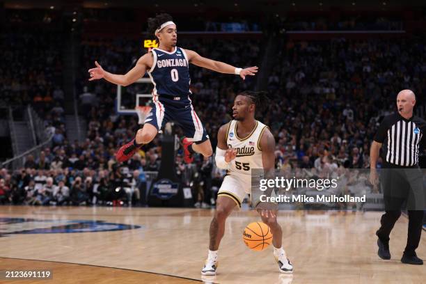 Lance Jones of the Purdue Boilermakers dribbles as Ryan Nembhard of the Gonzaga Bulldogs jumps to defend him during the first half in the Sweet 16...