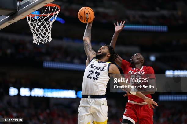 David Joplin of the Marquette Golden Eagles scores on a fast break as Mohamed Diarra of the North Carolina State Wolfpack defends during the 2nd half...