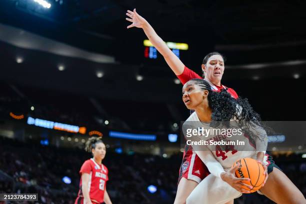 Kiki Iriafen of the Stanford Cardinal makes a move past Mimi Collins of the NC State Wolfpack during the second half in the Sweet 16 round of the...