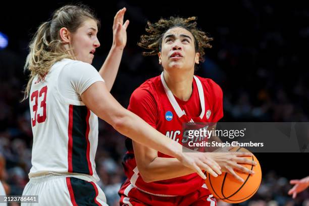 Madison Hayes of the NC State Wolfpack drives past Hannah Jump of the Stanford Cardinal during the second half in the Sweet 16 round of the NCAA...