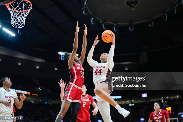 Kiki Iriafen of the Stanford Cardinal shoots over Saniya Rivers of the NC State Wolfpack during the second half in the Sweet 16 round of the NCAA...
