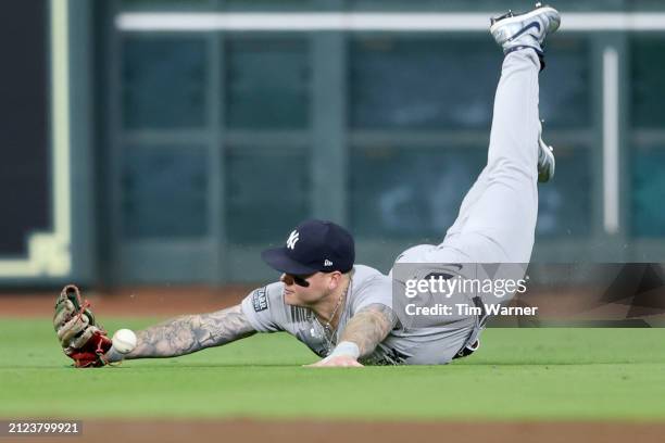 Alex Verdugo of the New York Yankees makes an unsuccessful diving attempt to catch a fly ball in the third inning against the Houston Astros at...