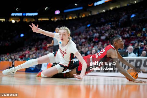 Cameron Brink of the Stanford Cardinal and Saniya Rivers of the NC State Wolfpack fall after going for a rebound during the second half in the Sweet...