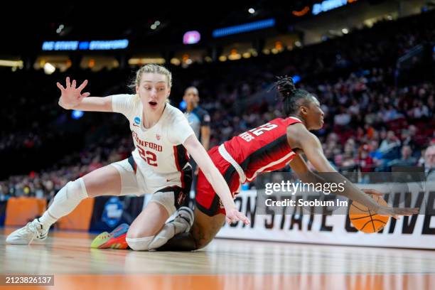 Cameron Brink of the Stanford Cardinal and Saniya Rivers of the NC State Wolfpack fall after going for a rebound during the second half in the Sweet...