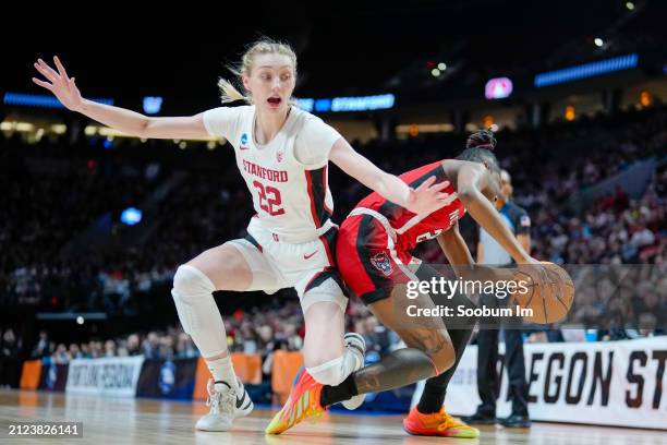 Cameron Brink of the Stanford Cardinal and Saniya Rivers of the NC State Wolfpack fall after going for a rebound during the second half in the Sweet...