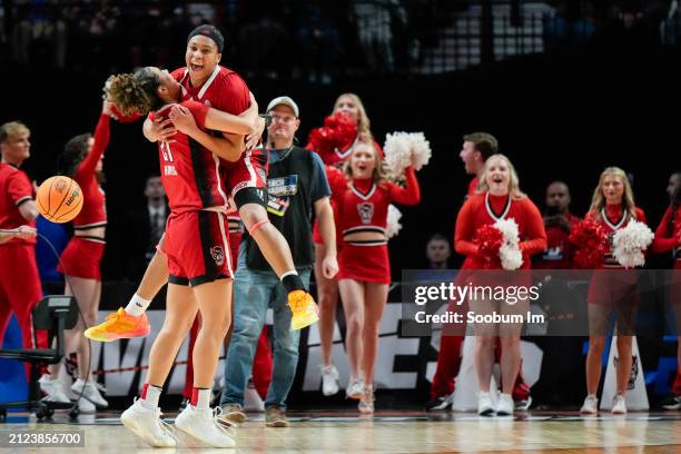 Madison Hayes and Zoe Brooks of the NC State Wolfpack celebrate after defeating the Stanford Cardinal 77-67 in the Sweet 16 round of the NCAA Women's...