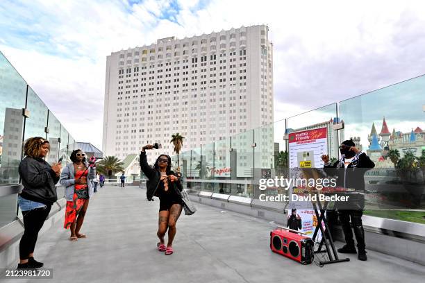 Woman dances her way across one of the pedestrian bridges leading away from the Tropicana Las Vegas on March 29 in Las Vegas, Nevada. The...