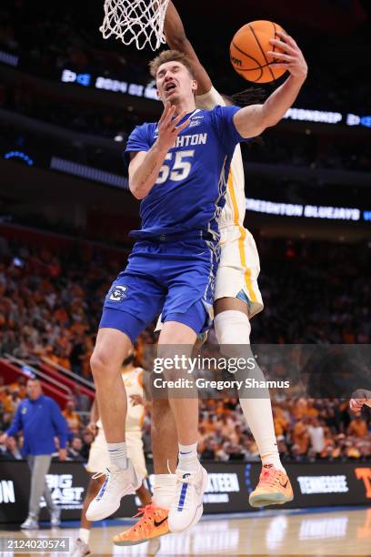 Baylor Scheierman of the Creighton Bluejays drives to the basket against Jonas Aidoo of the Tennessee Volunteers during the second half in the Sweet...