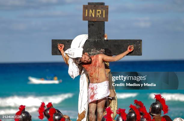 Man playing the role of Jesus Christ lies on the cross during the representation of 'The Way of The Cross' as part of the Holy Week celebrations at...