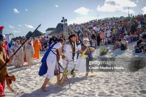 Man playing the role of Jesus Christ is arrested during the representation of 'The Way of The Cross' as part of the Holy Week celebrations at Playa...